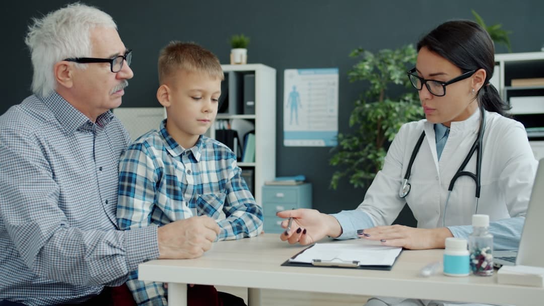 Doctor consults with grandfather and grandson in office.. Cover image for: Documenting GLP-1 and Weight-Management Visits With an AI Scribe.
