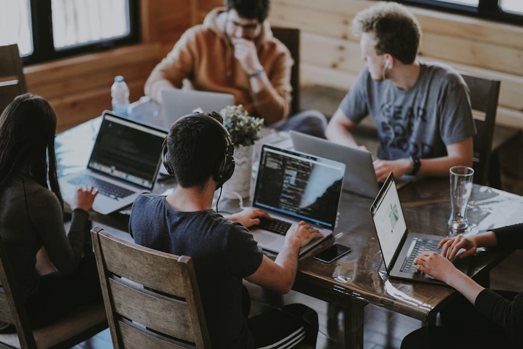 group of people using laptop computer. Cover image for: How to Choose the Best AI Medical Scribe Software in 2026.