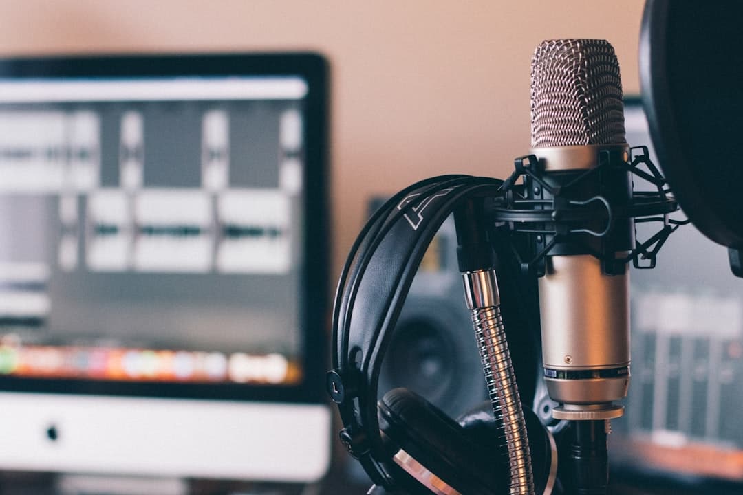 black and silver headphones on black and silver microphone. Cover image for: Can an AI Scribe Replace Your Medical Transcriptionist?.