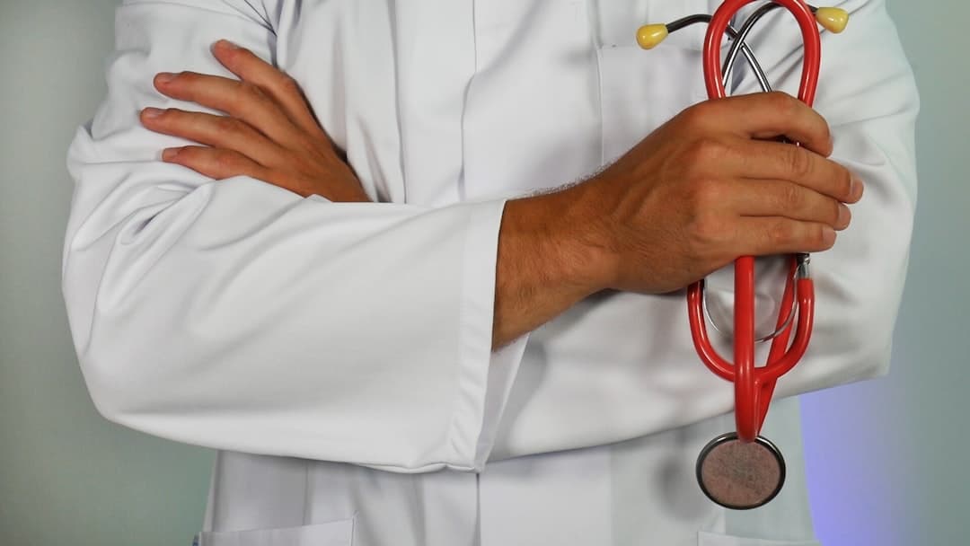 doctor holding red stethoscope. Cover image for: AI Scribe in Cardiology and Complex Decision-Making Specialties.