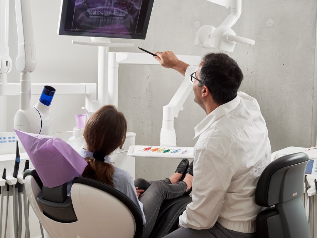 man in white dress shirt holding black pen. Cover image for: AI Medical Scribe for Dentistry and Oral Surgery.