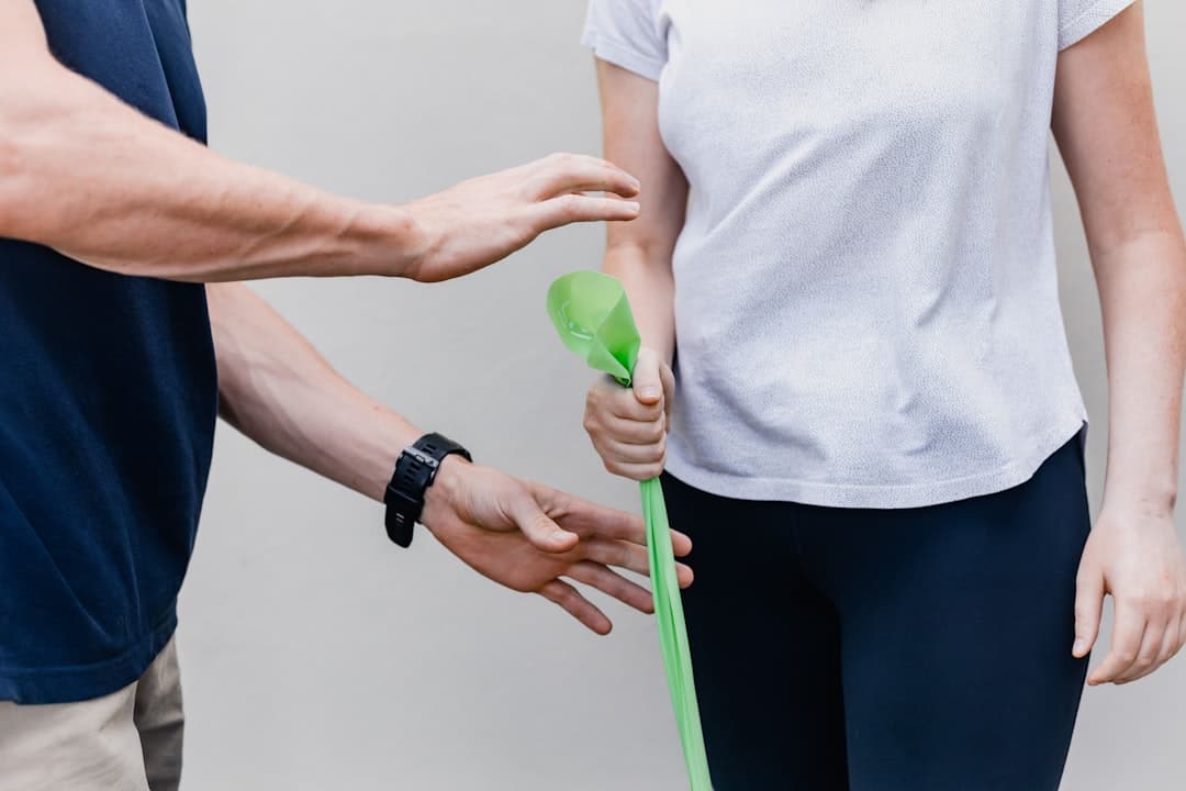 a person holding a green object in their hand. Cover image for: AI Medical Scribe for Physical Therapy and Rehabilitation.