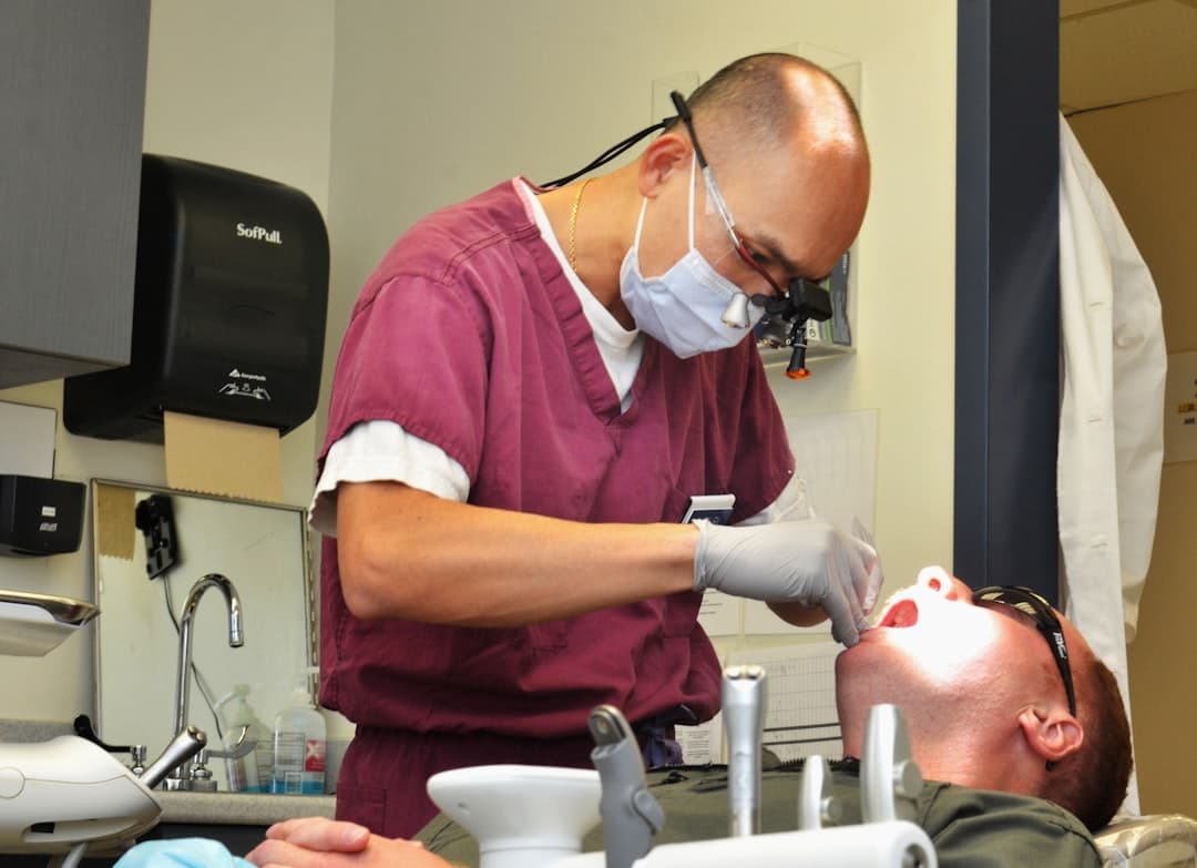 Dentist examining a patient's teeth in a clinic.
